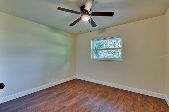 spare room with hardwood / wood-style flooring and ceiling fan