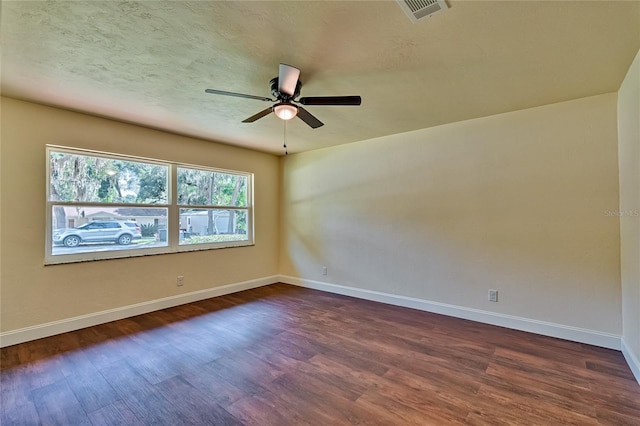 empty room featuring dark wood-type flooring and ceiling fan