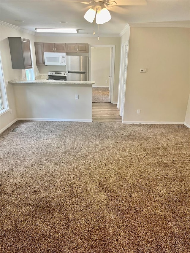 2905 SW Archer Rd Unit T4028, Gainesville, FL 32608 - kitchen featuring white microwave, freestanding refrigerator, electric range oven, crown molding, and light carpet