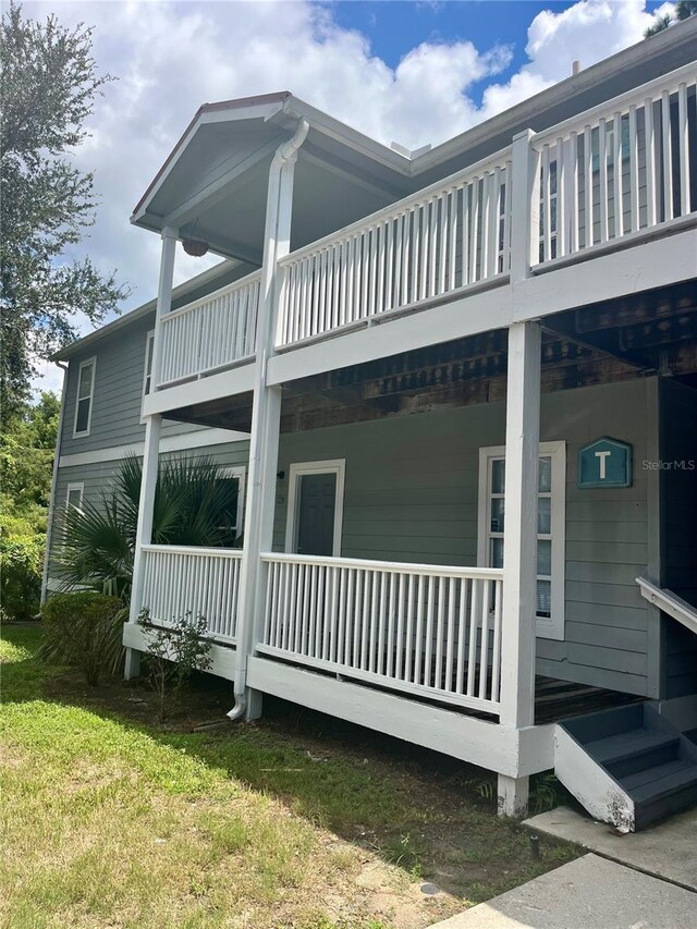 2905 SW Archer Rd Unit T4028, Gainesville, FL 32608 - view of property exterior with a balcony, a porch, and a yard