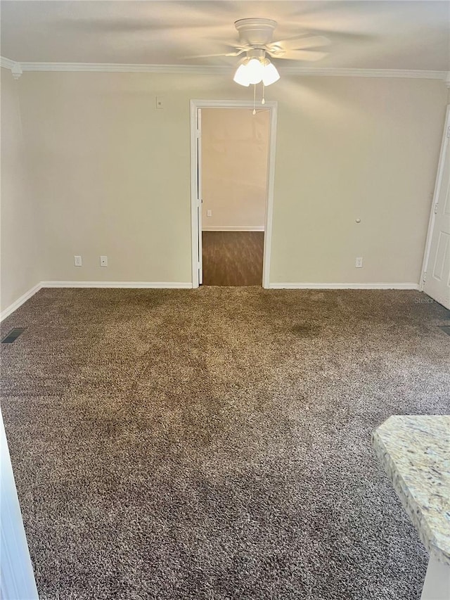 unfurnished room featuring crown molding, ceiling fan, and carpet floors