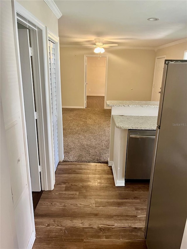 corridor featuring crown molding and dark colored carpet