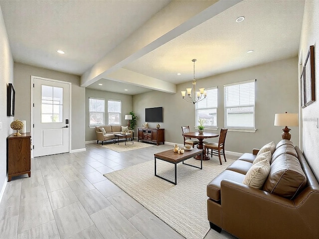 living room featuring an inviting chandelier, light tile patterned floors, a textured ceiling, and beamed ceiling