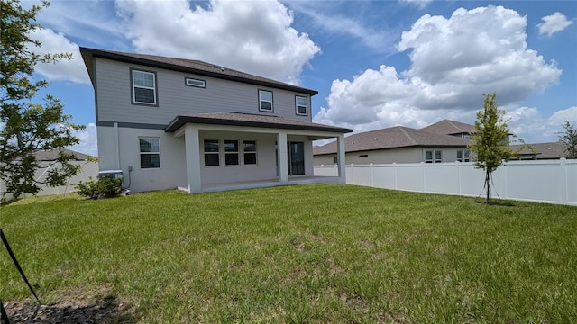 rear view of house with a patio, a yard, and cooling unit