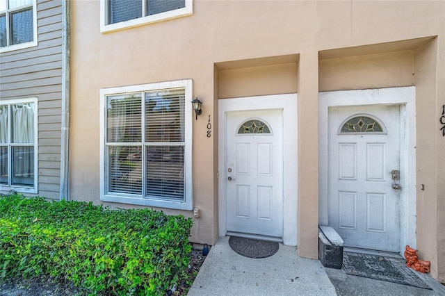 doorway to property with stucco siding