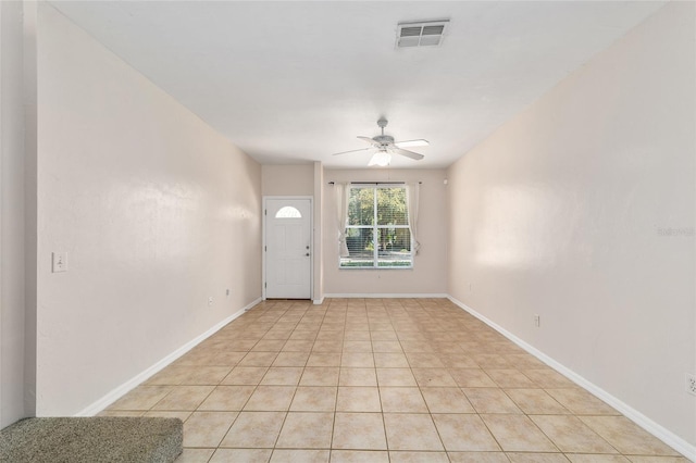 entrance foyer featuring light tile patterned floors, baseboards, visible vents, and a ceiling fan