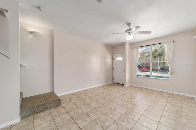 foyer featuring stairs, ceiling fan, baseboards, and light tile patterned floors