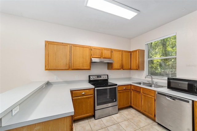 kitchen with light tile patterned floors, stainless steel appliances, light countertops, under cabinet range hood, and a sink