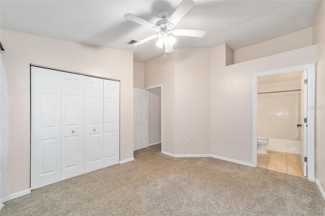 unfurnished bedroom featuring baseboards, visible vents, a closet, and light colored carpet