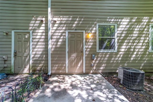 property entrance featuring central AC and a patio