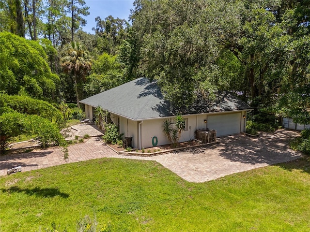 view of front of property with a garage and a front lawn