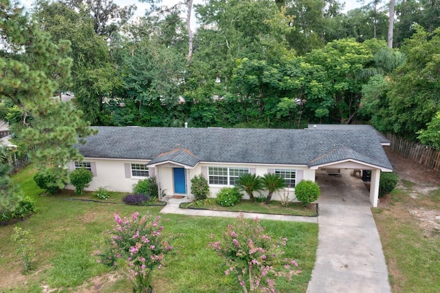 ranch-style house featuring a front yard and a carport