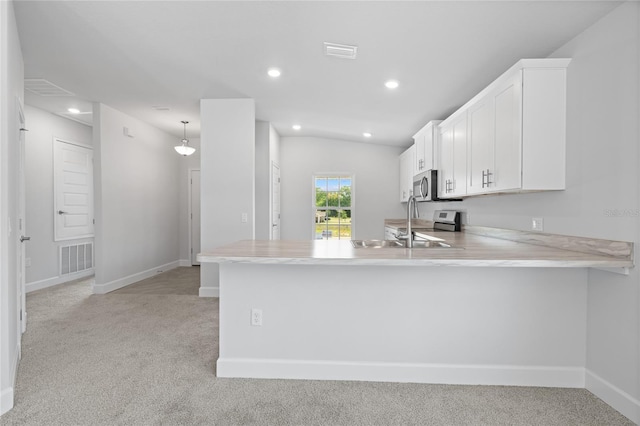 kitchen featuring visible vents, light colored carpet, appliances with stainless steel finishes, and light countertops