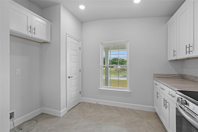 kitchen with recessed lighting, white cabinetry, stainless steel electric stove, and light countertops