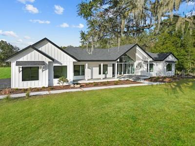 rear view of property with a yard