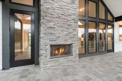 interior space with a patio area and an outdoor stone fireplace