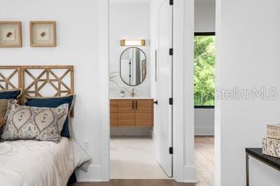 bedroom featuring multiple windows and light hardwood / wood-style flooring