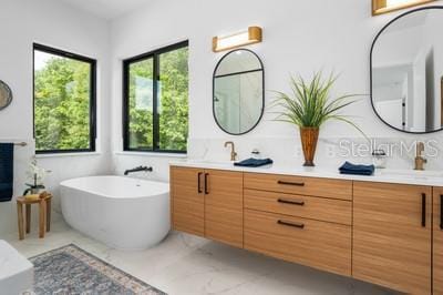 bathroom featuring vanity and a bath