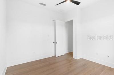 empty room featuring wood-type flooring and ceiling fan