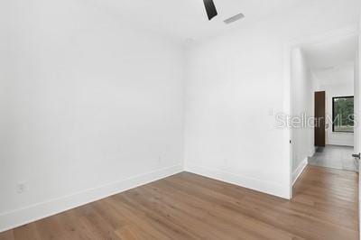 unfurnished room with wood-type flooring