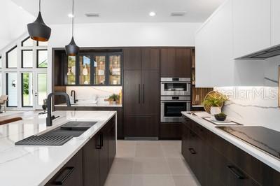 19010 SW 21st Pl, Newberry, FL 32669 - kitchen with pendant lighting, double oven, white cabinetry, sink, and decorative backsplash