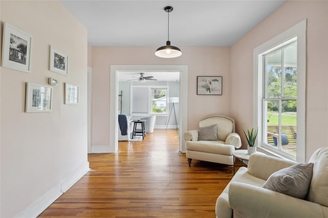 sitting room with hardwood / wood-style flooring, ceiling fan, and a healthy amount of sunlight