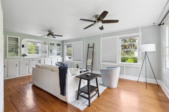 living room featuring ceiling fan, plenty of natural light, and hardwood / wood-style floors