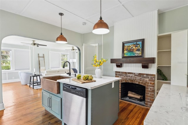 kitchen with pendant lighting, dishwasher, a healthy amount of sunlight, and dark hardwood / wood-style floors