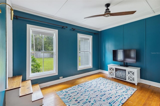 living room featuring hardwood / wood-style floors and ceiling fan