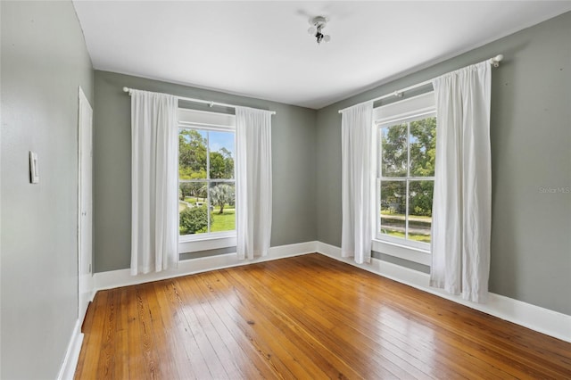 empty room featuring hardwood / wood-style flooring and a wealth of natural light