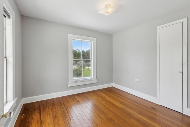 unfurnished room with hardwood / wood-style flooring