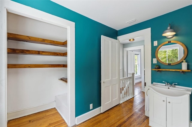 bathroom with vanity and hardwood / wood-style flooring