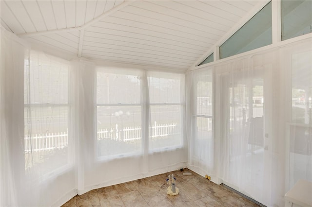 unfurnished sunroom featuring lofted ceiling