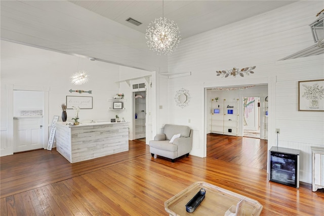 unfurnished living room featuring hardwood / wood-style floors and a chandelier