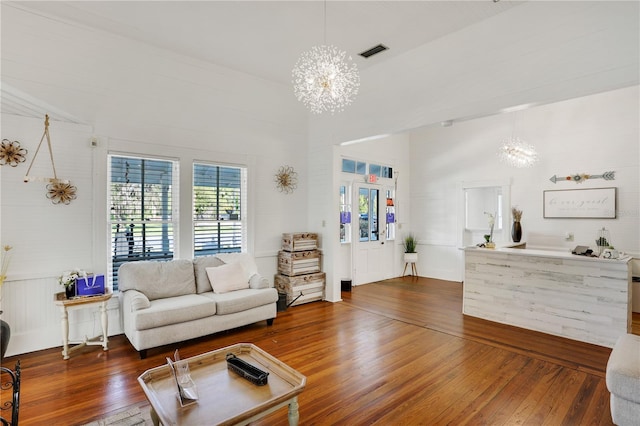 living room featuring dark hardwood / wood-style flooring and a chandelier