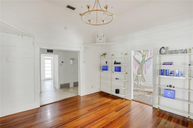 interior space with hardwood / wood-style floors and a notable chandelier