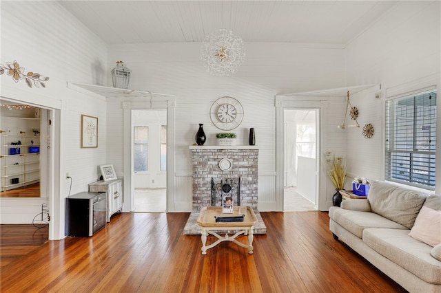 living room with hardwood / wood-style flooring, plenty of natural light, and a fireplace