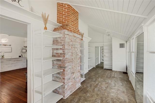 interior space with hardwood / wood-style flooring, vaulted ceiling, and a chandelier