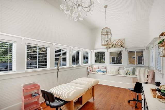 sunroom with an inviting chandelier and breakfast area