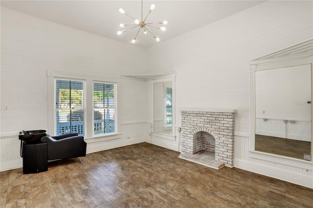 unfurnished living room featuring a notable chandelier and a fireplace