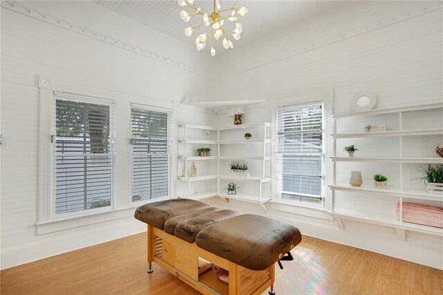 living area with hardwood / wood-style floors and an inviting chandelier