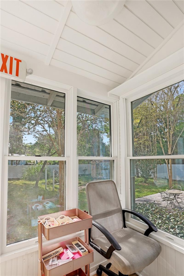 sunroom featuring vaulted ceiling