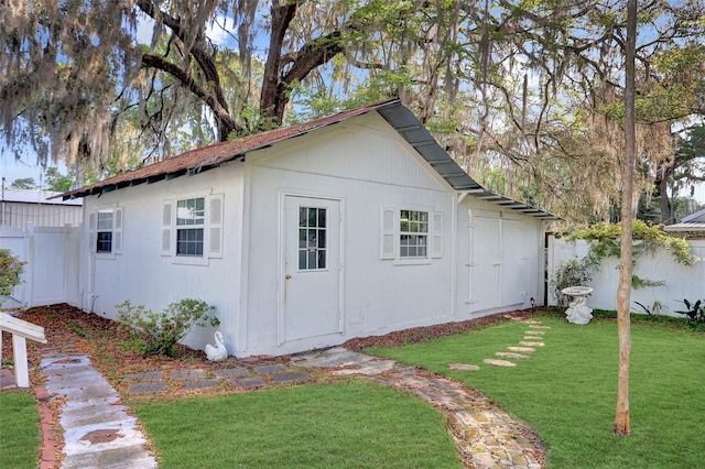 view of outbuilding with a lawn