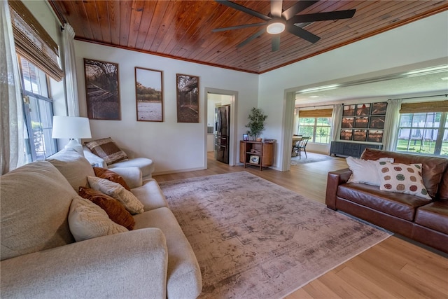 living room with ornamental molding, wooden ceiling, ceiling fan, and light wood-type flooring