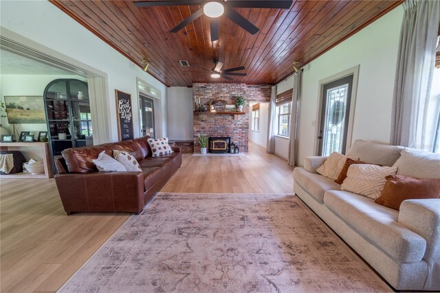 living room with wood ceiling, ceiling fan, brick wall, a fireplace, and wood-type flooring