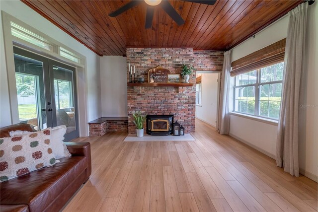 living room with wood ceiling, brick wall, light hardwood / wood-style flooring, and french doors