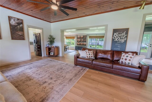 living room featuring light wood-type flooring, ceiling fan, ornamental molding, and wooden ceiling