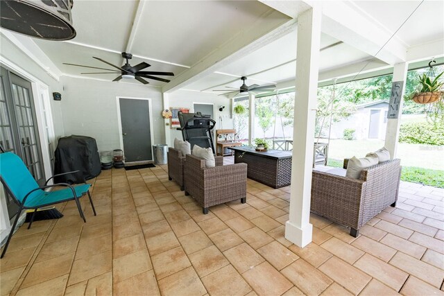 view of patio with an outdoor living space and ceiling fan