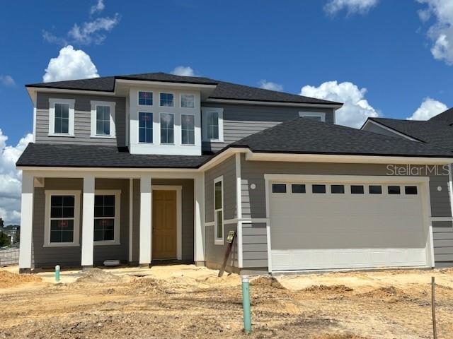 prairie-style home with a garage and a porch