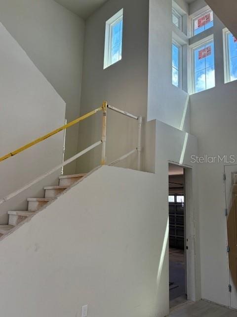 stairway featuring a high ceiling